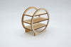 A small wooden display shelf with three tiers and an open circular frame design, shown on a light gray studio background.