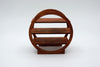 A small round wooden display shelf with three tiers and a circular frame, shown on a light gray studio background.