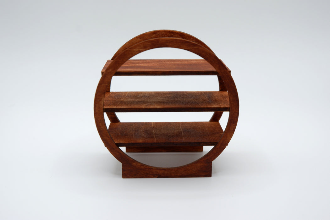 A small round wooden display shelf with three tiers and a circular frame, shown on a light gray studio background.