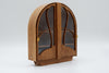 1:12 scale wooden miniature of an arch-topped display cabinet. It has 2 doors with clear plastic windows that hinge open from the center. Each door has a gold-colored oval knob.